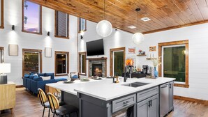 A spacious kitchen with a large island, wooden ceiling, and a fireplace. - 100% Kids & Adults LOVE this Cabin! Heated Pool, Espresso Bar, Playset, Pool Tbl (Broken Bow)