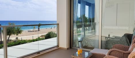 A balcony with a view of the beach and ocean.