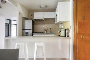 Enjoy cooking in this well-equipped kitchen with a central island, oven, and range hood.