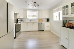 Enjoy cooking in this well-equipped kitchen with a refrigerator, oven, microwave, and dishwasher.