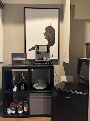 Enjoy a convenient kitchenette with a coffee machine, refrigerator, and ample storage.