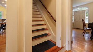 A staircase with wooden steps and a dark carpet at the bottom. - Family Pet Friendly 4BR in N.E. Harbor[Millbrook] (Mount Desert)