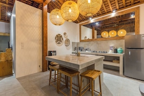 Enjoy cooking in this well-equipped kitchen with a central island, stove, and ample counter space.