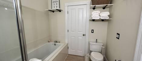 Bathtub, jetted bath, hair dryer, towels