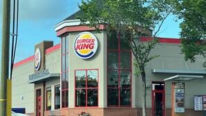 A Burger King restaurant with a modern design, large windows, and a visible outdoor seating area. - Cozy  3 beds Suite Near Calgary Airport, Quiet, Clean & Convenient Sleeps 7 (Calgary)