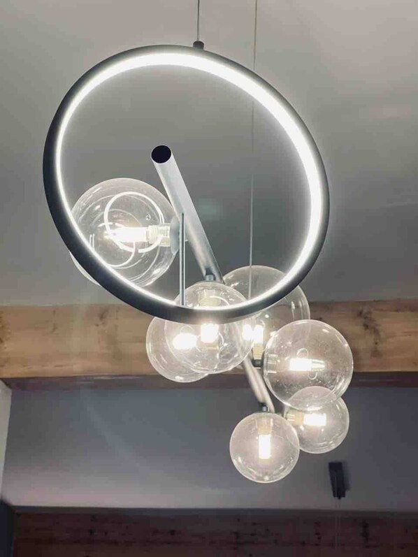 A modern chandelier with multiple spherical glass bulbs and a circular metal frame. - The Windmill, Lytham St Annes (Lytham St Annes)