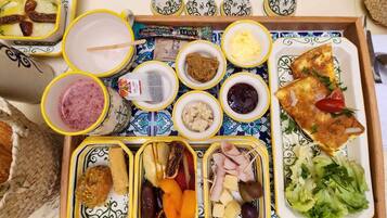A tray with various food items including bread, cheese, and vegetables.