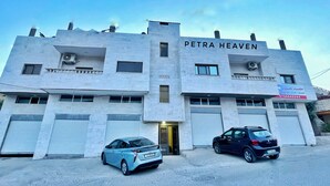 A building named "PETRA HEAVEN" with two cars parked in front. - Petra Heaven (Wadi Musa)