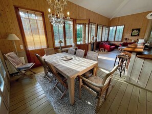 A wooden-paneled room with a dining table, chairs, and a chandelier. - Top located Cap Ferret style villa + Jacuzzi A0379 (Lège-Cap-Ferret)