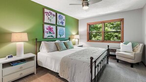 A bedroom with a bed, bedside tables, a chair, a window, and wall art. - Front Porch Therapy - Escape to your hideaway only 6 minutes above Boone (Boone)