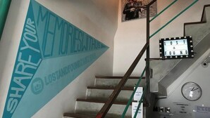 A staircase with a sign that reads "SHARE YOUR MORALES WITH US" and a "LOST & FOUND" sign. - Lost & Found Dooms (Zanzibar Town)