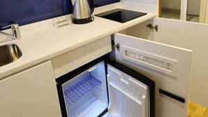 Apartamento básico | Cozinha privada | Frigobar, cooktop, chapa, talheres/pratos/utensílios de cozinha