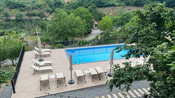 Seasonal outdoor pool, pool umbrellas, pool loungers
