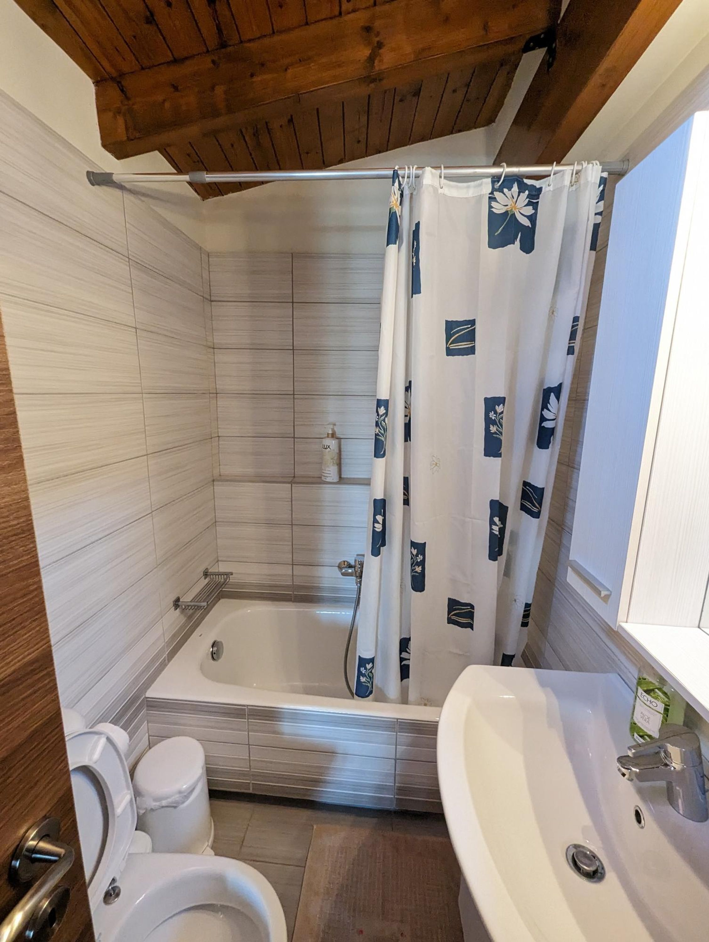 Ein Badezimmer mit Dusche, Toilette und Waschbecken.