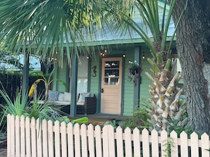A porch with a wooden fence, a bench, and hanging plants. - 3BR/3BA Charming Key West Style Home in Downtown Saint Augustine (St. Augustine)