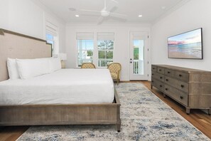 A bedroom with a bed, a dresser, a chair, and a painting on the wall. - Santa Rosa Beach Blonde~ New with Elevator (Santa Rosa Beach)