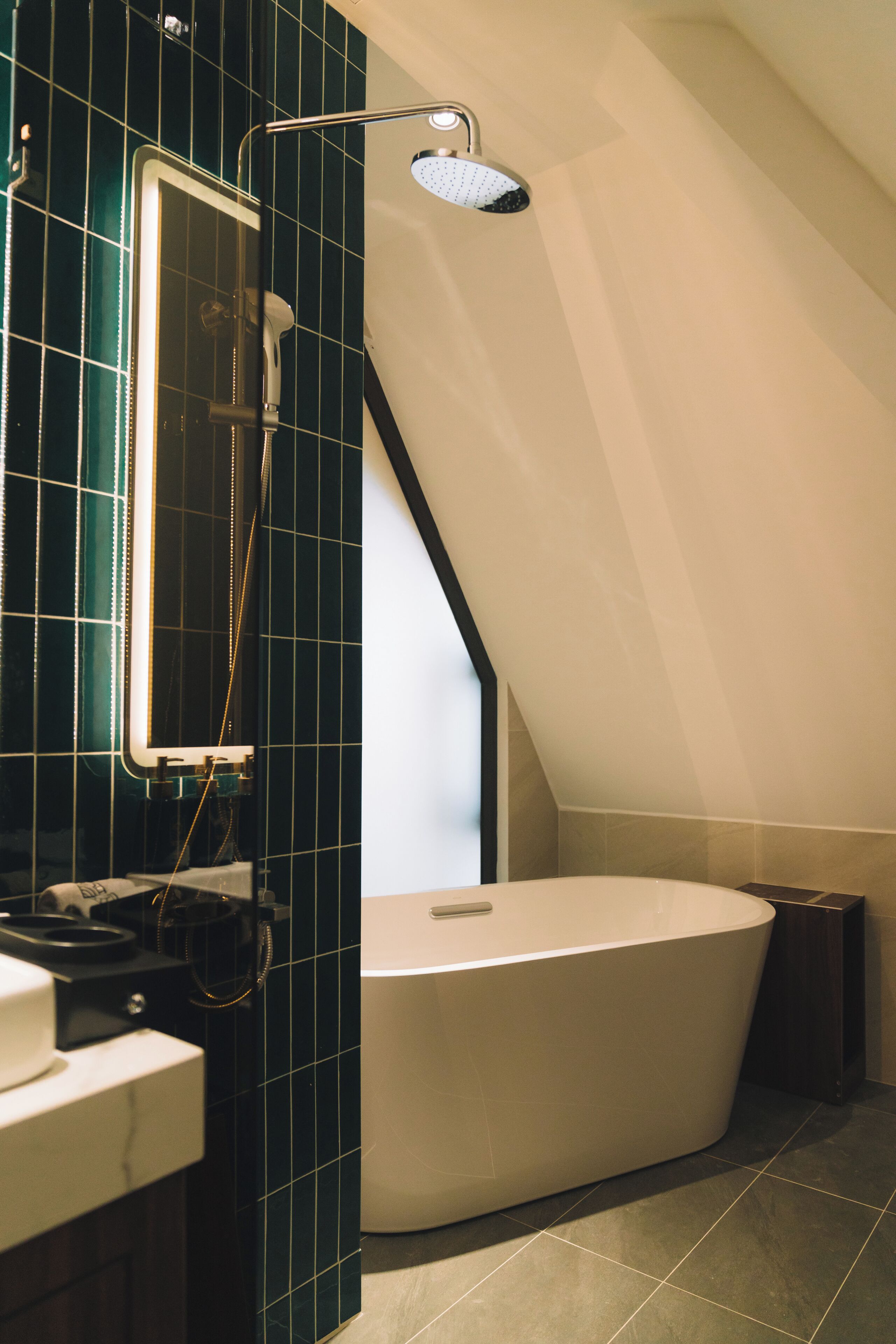 A modern bathroom with a freestanding bathtub, a glass-enclosed shower, and a mirror.