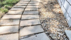 A curved stone pathway leading to a building with a white exterior. - Baboosic Lake - Wonderful Classic S. NH Vacation Cottage all to Yourself (Merrimack)