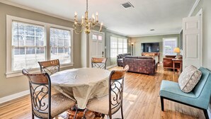 A spacious living room with a dining table, chairs, a sofa, and a TV. - Pine Bluff (Pine Bluff)