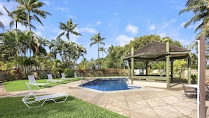 A swimming pool with lounge chairs and a gazebo in a landscaped area with palm trees. - "Da Koa Bar" Paradise at Turtle Bay -Trade Winds, Beaches, Sunshine Rain, Resort (Kahuku)
