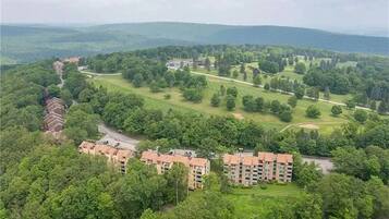 A residential area with apartment buildings, green spaces, and a golf course.