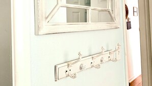 A room with a white wall, a window with a white frame, and a wall-mounted light switch panel. - Cozy Ranch Home, Centrally Located near Chicks Beach! (Virginia Beach)