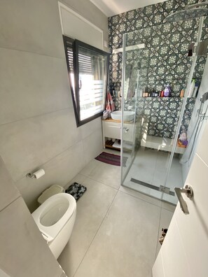 Chuveiro, toalhas de banho, papel higiênico 