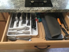 A kitchen drawer with utensils and a cutting board. - Mid-Century Tiny House in the heart of New River Gorge National Park (Oak Hill)