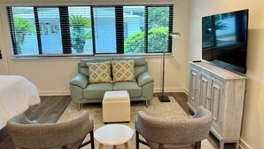 A living room with a sofa, two armchairs, a coffee table, a TV, and a cabinet. - Newly remodeled, heart of Seagrove Beach, 100 yards to beach! (Santa Rosa Beach)
