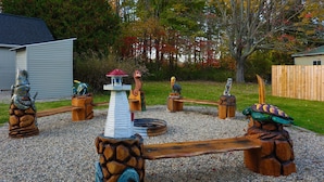A playground with wooden play structures, including a seesaw and a climbing area.