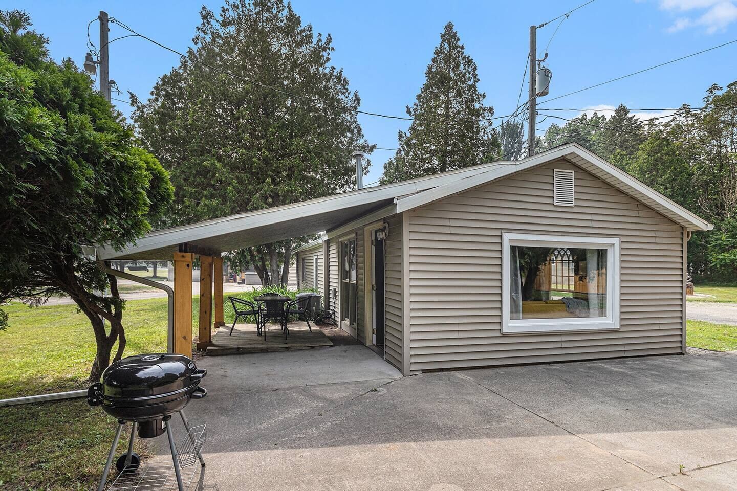 A small, single-story house with a covered patio area.