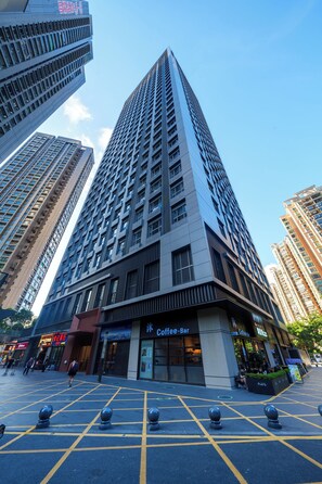 A tall building with a coffee bar on the ground floor. - Galory service apartment (Shenzhen)
