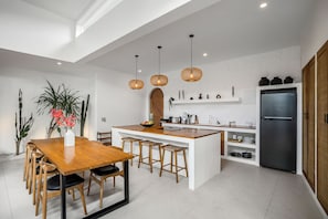 Enjoy cooking in this well-equipped kitchen with a central island, sink, and ample counter space.