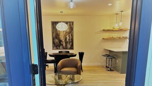 A modern interior with a dining area, a kitchen, and a living space. - Outlaw Inn Unit 4.  Newly Remodeled large unit! 2 minutes walk to Main Street.  (Ouray)