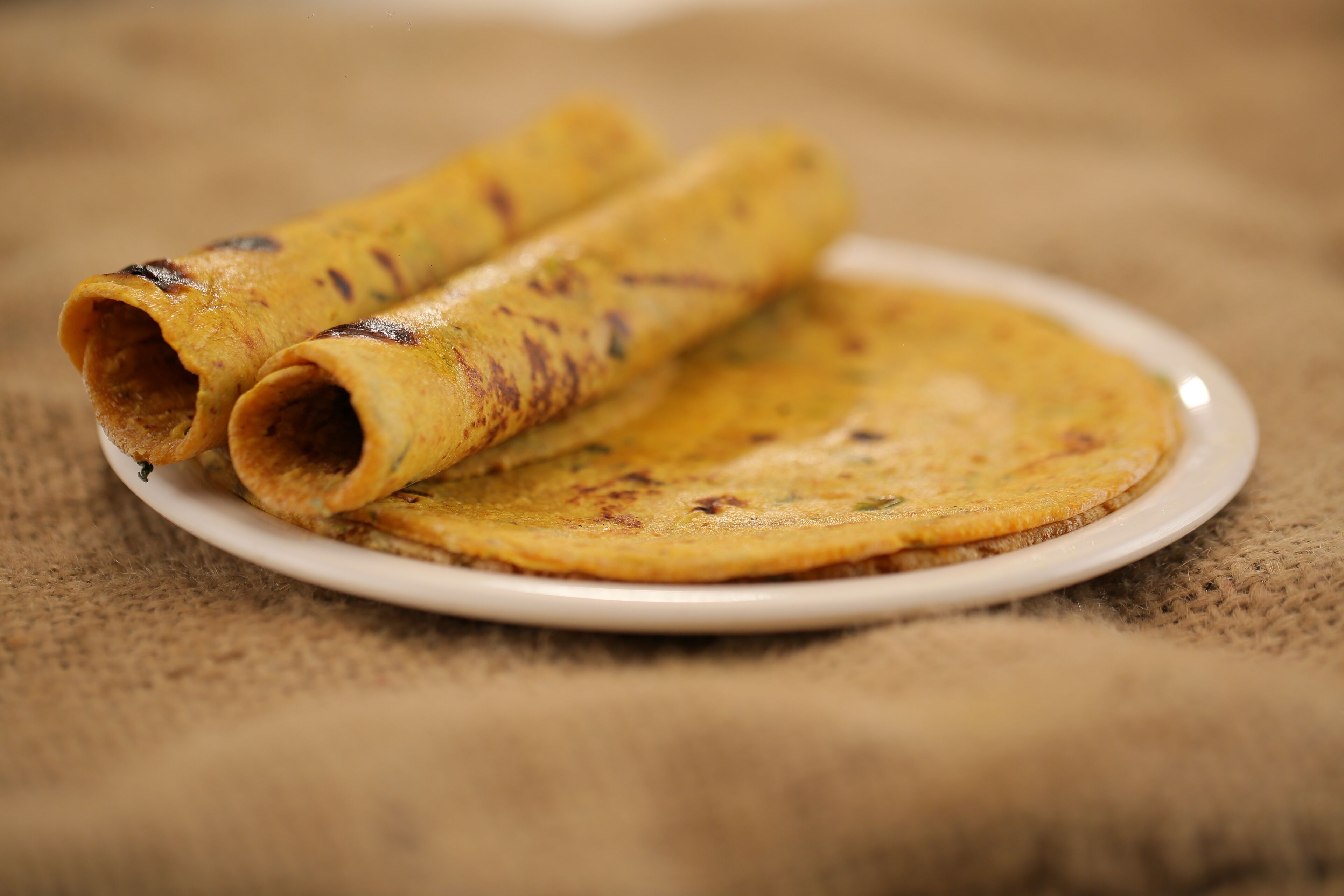 A plate with two rolled and one flat pancake.