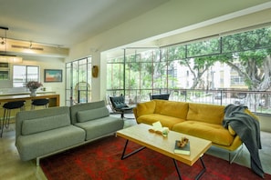 A modern living room with a sofa, armchair, and a coffee table.