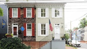 A two-story building with a front porch, a mailbox, and an American flag. - Charming Charles -Walkable Downtown Annapolis Home (Annapolis)