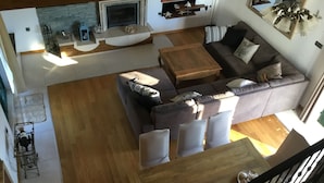A modern living area with a sofa, coffee table, and a fireplace. - Lavender Hill Hvar (Stari Grad)