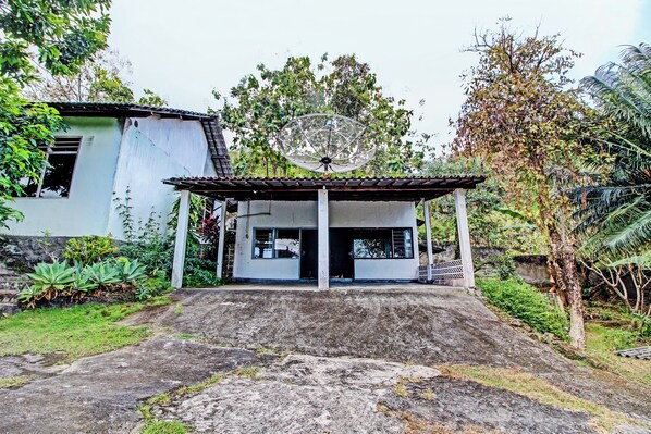 A house with a satellite dish, a covered porch, and a concrete driveway. - Hotel O Sendang Asri (Wonogiri)