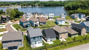 A residential area with houses, a lake, and a road. - Cozy Lake Cottage W/Pool, Hot Tub,Kayaks, SUPs (Winchester)