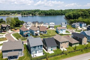 A residential area with houses, a lake, and a road. - Cozy Lake Cottage W/Pool, Hot Tub,Kayaks, SUPs (Winchester)