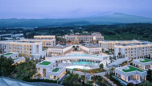 A large hotel complex with multiple buildings, a central courtyard with a swimming pool, and surrounding greenery. - The Siena Resort (Seogwipo)