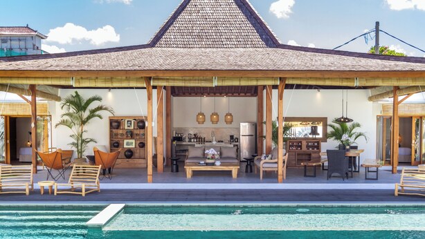 A poolside area with a covered seating area, a kitchen, and a dining space. - Villa Hana by Alfred in Bali (Seminyak)