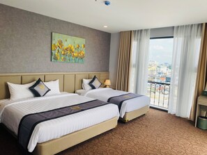Habitación triple Deluxe, vista a la ciudad | Ropa de cama de alta calidad y minibar 