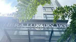 A hotel sign reading "HERA LUXURY HOTEL" with a modern architectural design and visible balconies. - Hera Luxury Hotel (Ho Chi Minh City)