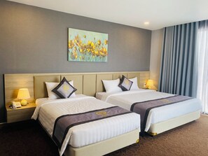 Deluxe Triple Room, City View | Premium bedding, minibar, in-room safe, individually decorated - Hera Luxury Hotel (Ho Chi Minh City)