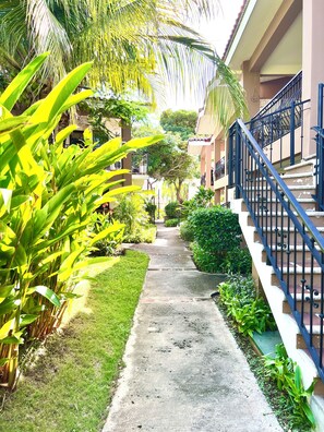 A pathway leading to a building with a blue staircase.