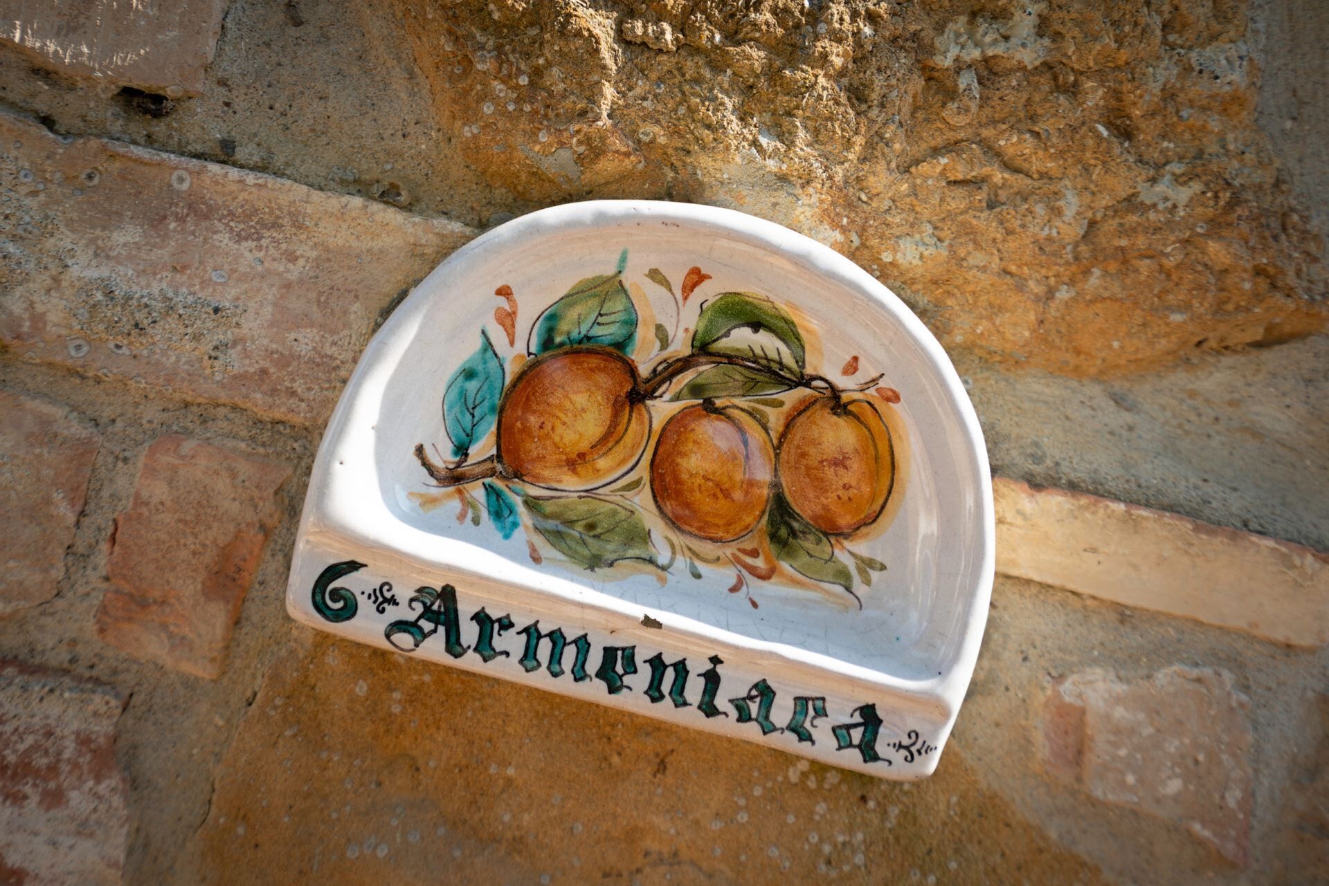 Une assiette en céramique ornée d’illustrations de fruits et portant l’inscription « Arménie ».