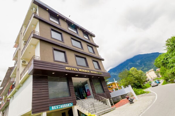 A multi-story building with a restaurant on the ground floor and a hotel named "Hotel Mirage Residency" on the upper floors. - Hotel Mirage Residency (Dharamshala)