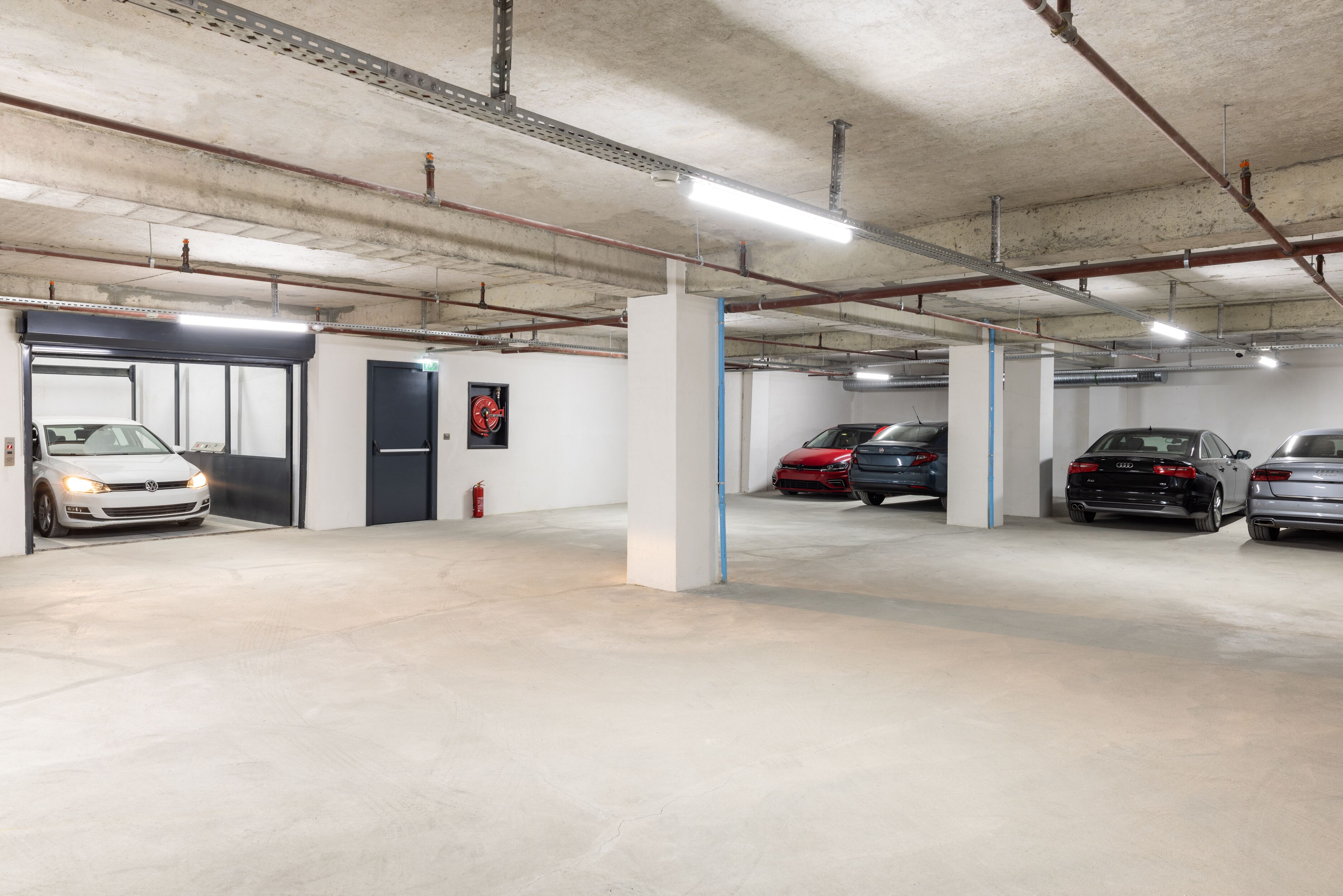 A multi-level parking garage with several cars parked.